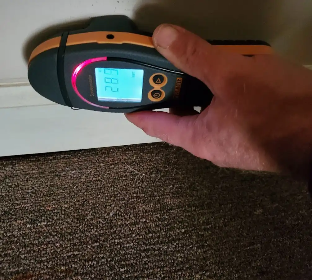 Moisture detection at baseboard during Storm Damage Restoration in Kirby